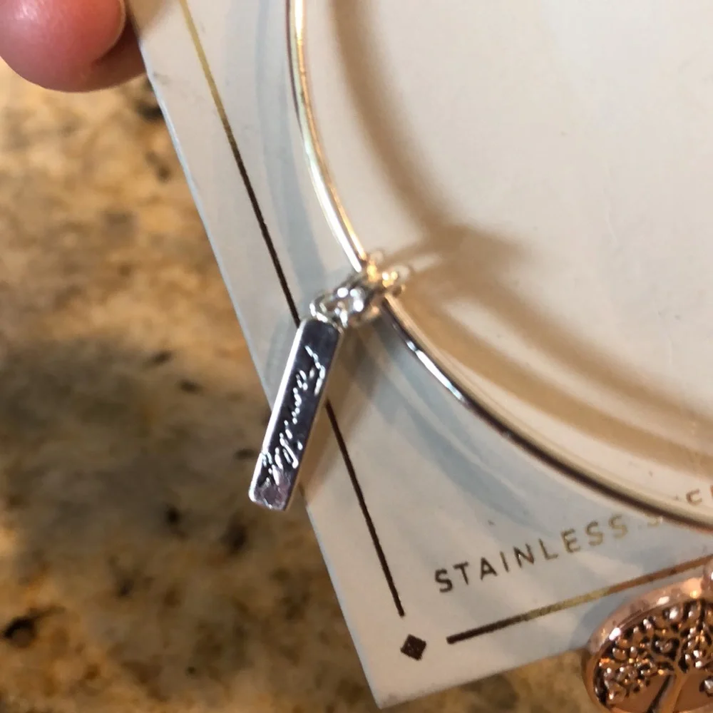new Silver-finish bracelet with a sleek wire design and 3 hanging charms